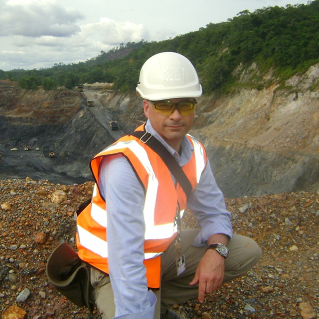 Micahel Hayes-Rivet, PVA consultant, kneeling at a mine site